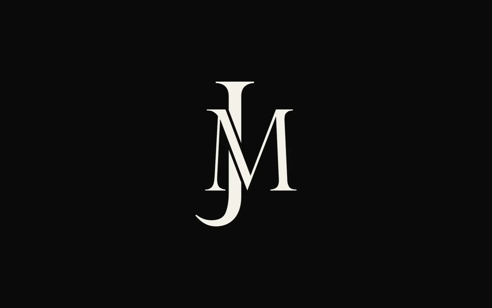 The JM monogram in cream on black: a tall serif J threaded through an M.