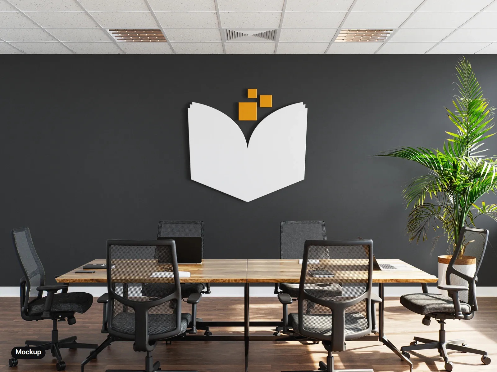 Mockup: the mark as a white dimensional book with amber pixels on a charcoal meeting-room wall, above a wooden table and black office chairs.