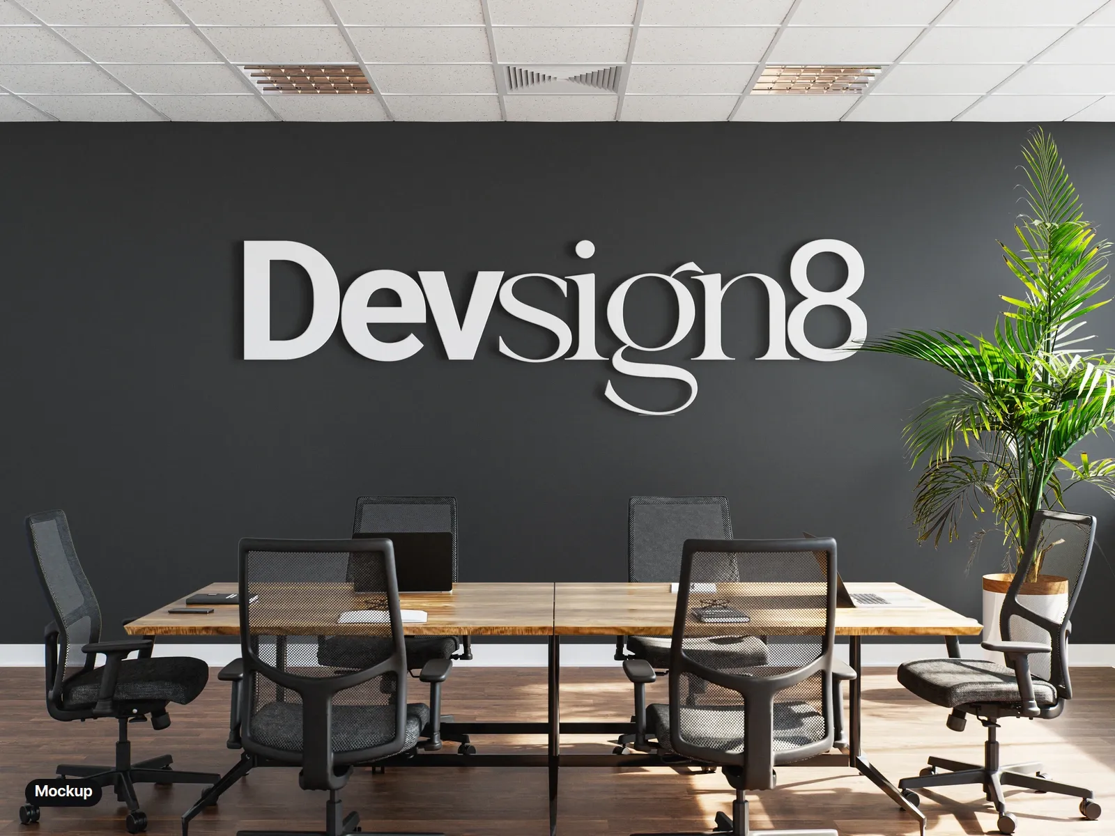 Mockup: the wordmark as white dimensional letters on a charcoal meeting-room wall, above a wooden table and black office chairs.