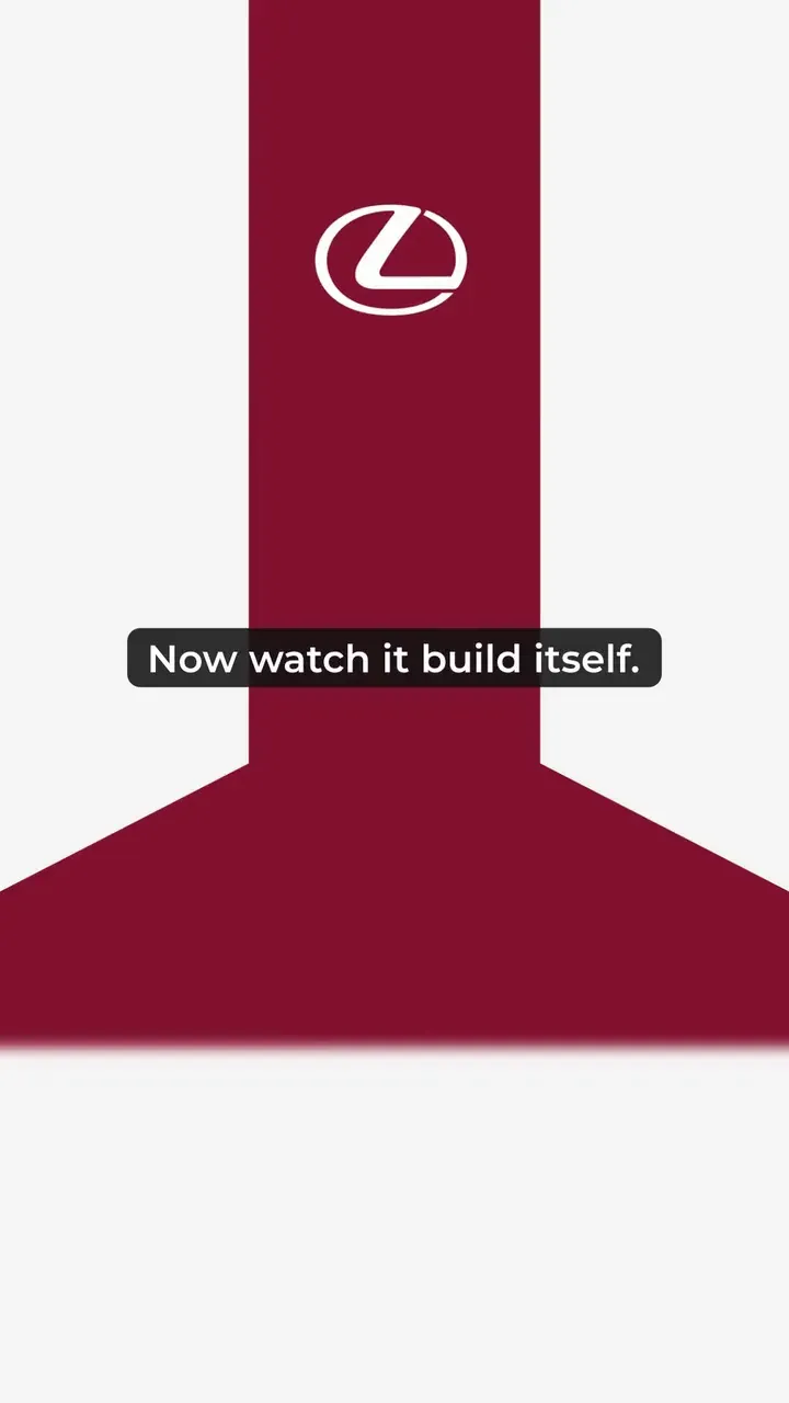 The Reveal building: a deep red band on a pale grey page with the Lexus emblem, under the caption Now watch it build itself.